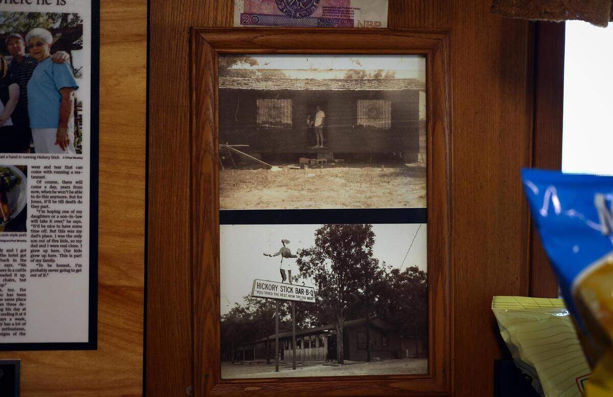 A photograph of Hickory Stick Barbecue before it opened in 1976 is framed on top of a second photo taken in 1979. Mark Jones, the current owner, was 14 when his father opened the restaurant.